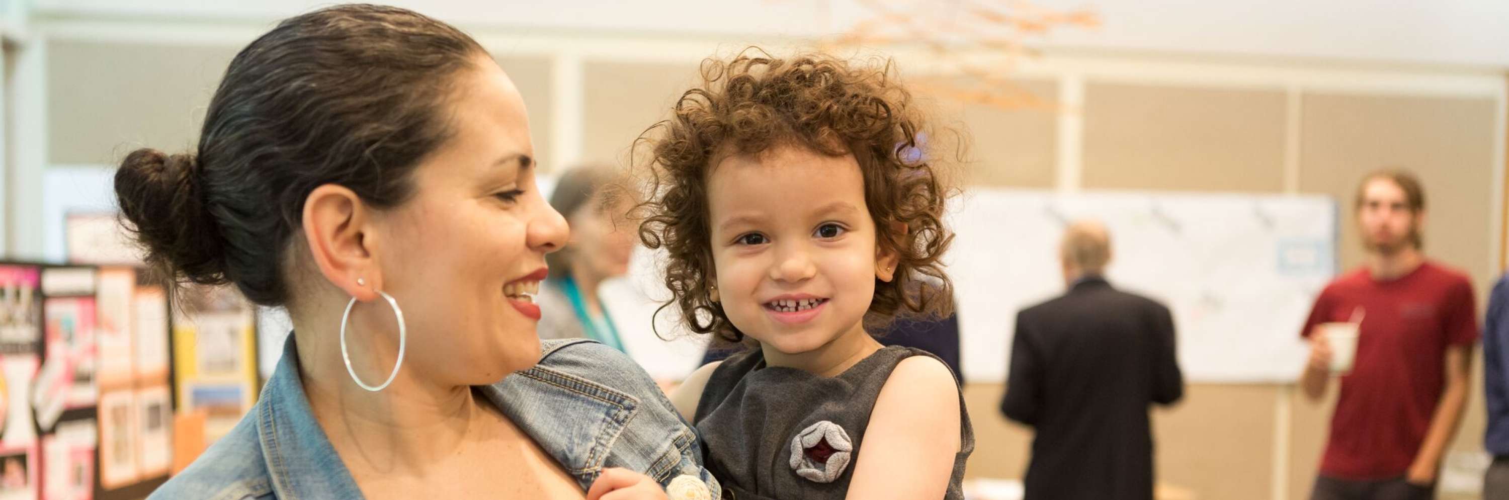 mother holding her toddler during coffee hour after worship